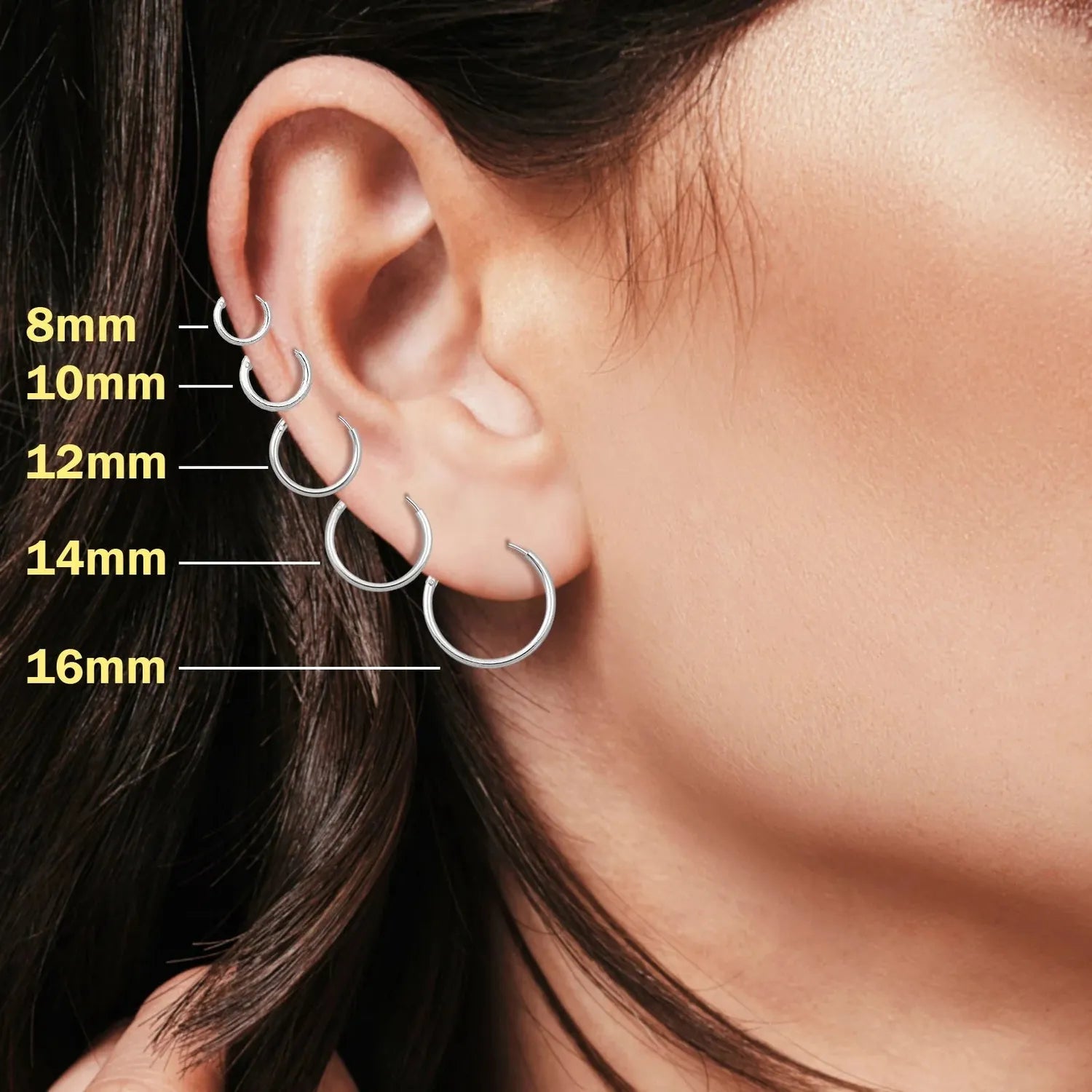 Melchior Jewellery model wearing sterling silver rhodium plated hoop earrings in 8mm 10mm 12mm 14mm 16mm sizes