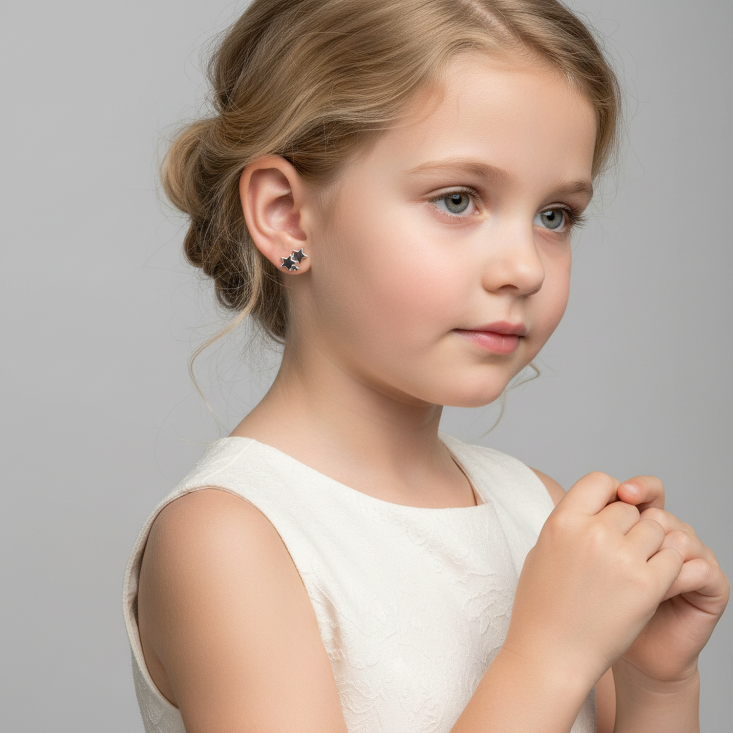 Melchior Jewellery sterling silver star stud earrings worn by young girl in white dress