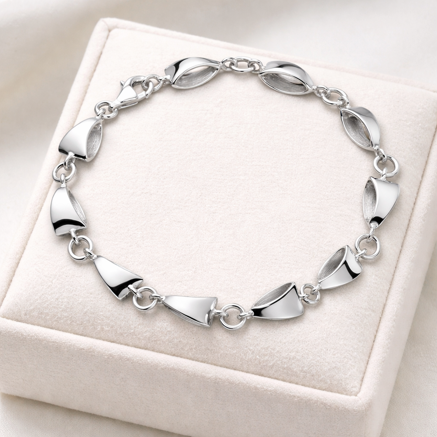 Sterling silver triangle bracelet by Melchior Jewellery with alternating polished and matte triangle links