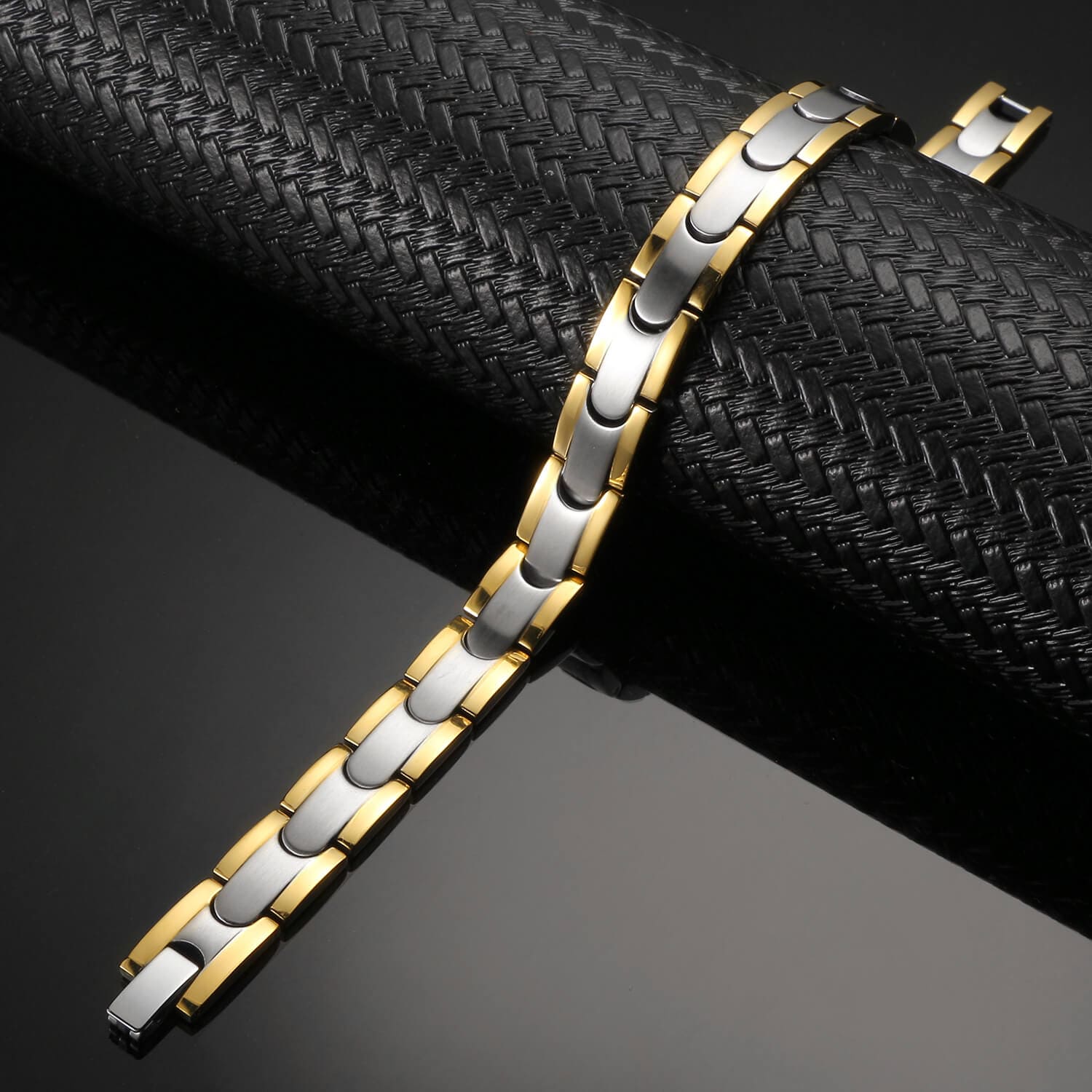 Melchior Jewellery two tone gold and silver link titanium magnetic therapy bracelet on black display