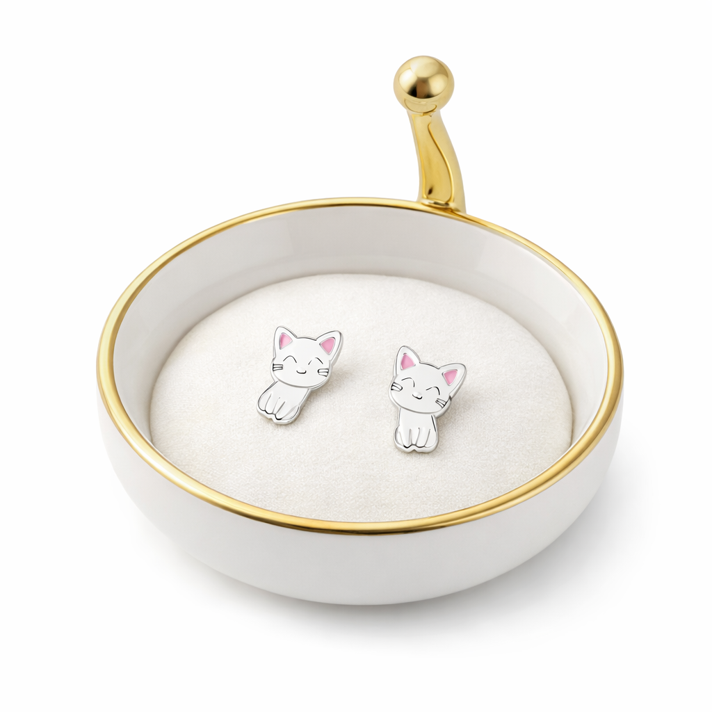 White cat stud earrings for kids displayed in a round white and gold jewellery dish by Melchior Jewellery