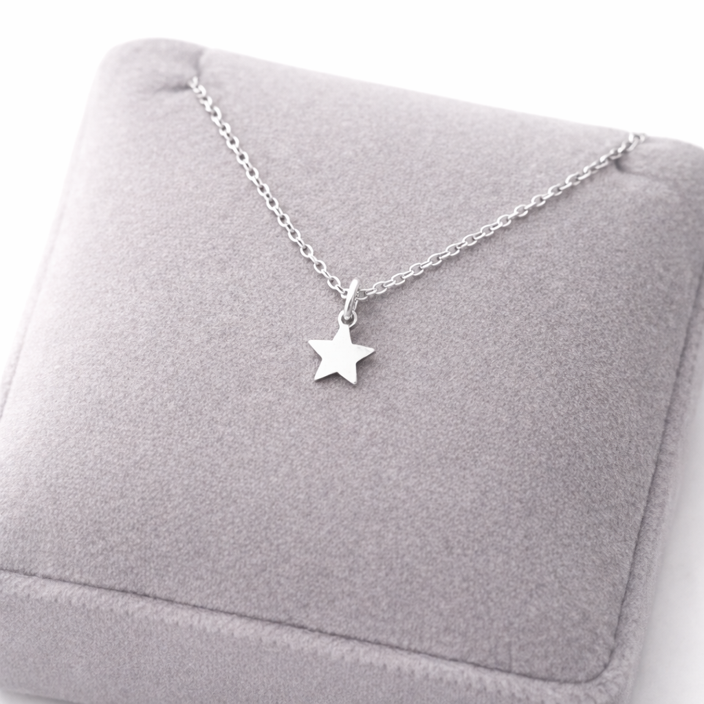 Melchior Jewellery womans plain star necklace sterling silver displayed on grey cushion