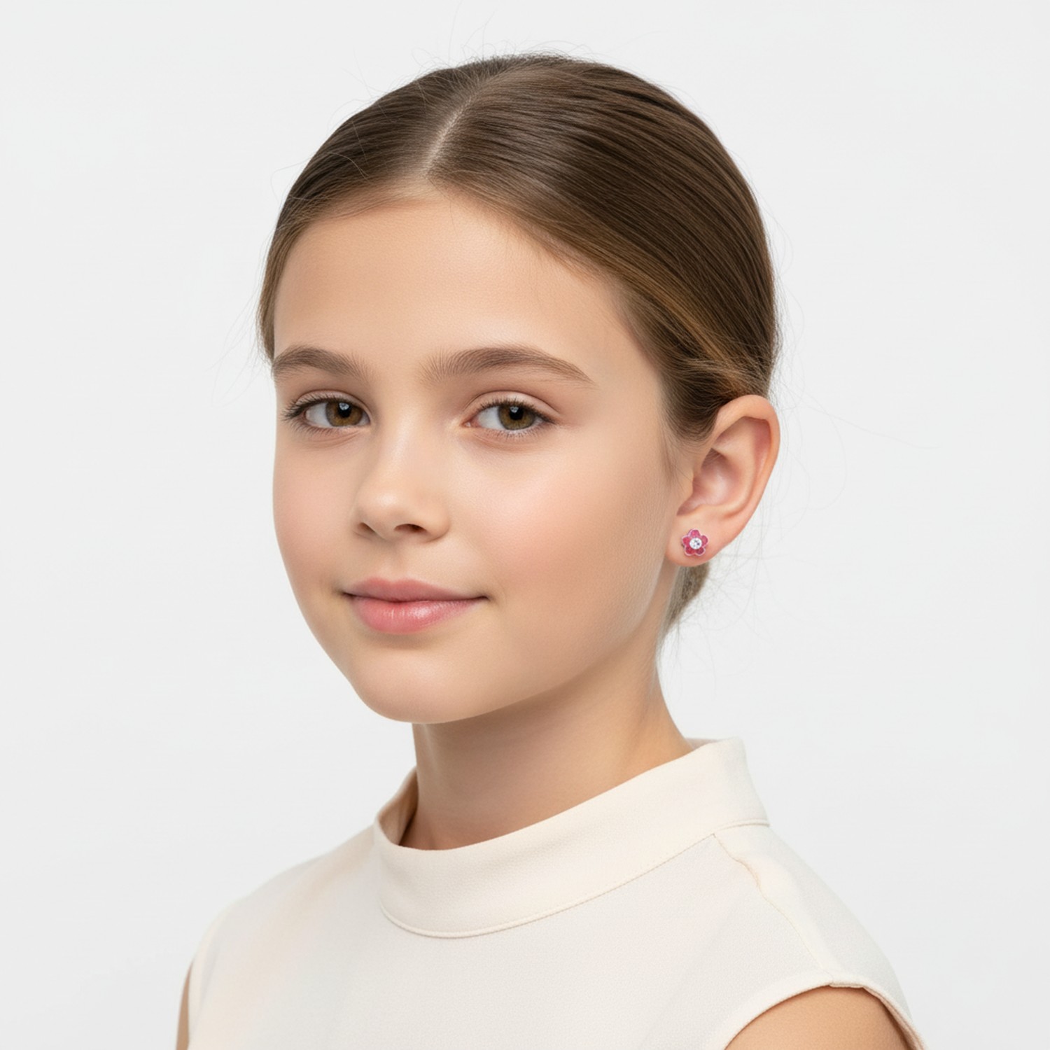 Girls pink flower stud earrings by Melchior Jewellery worn by a young girl with light brown hair