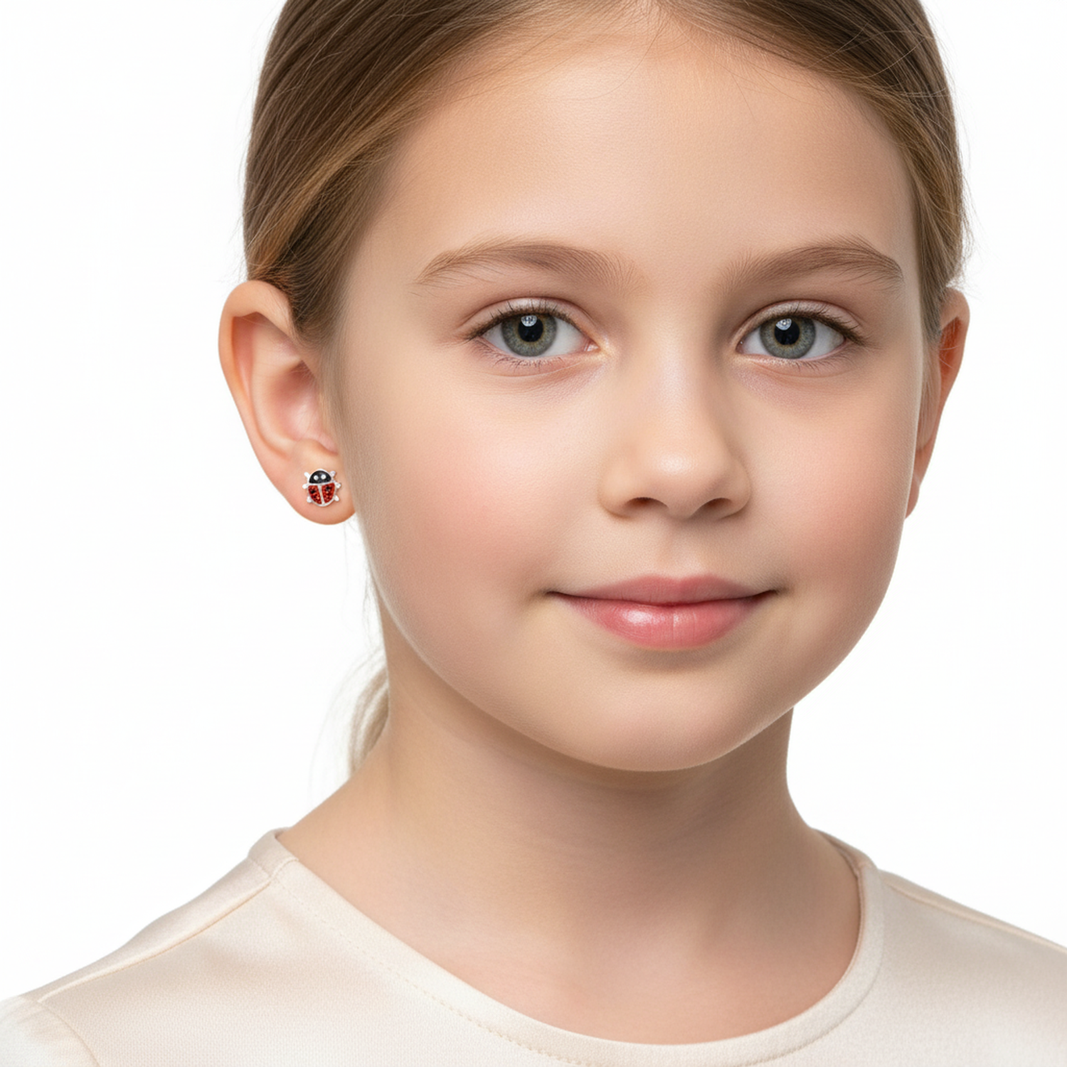 Child wearing Melchior Jewellery red glitter ladybird stud earrings on her left ear