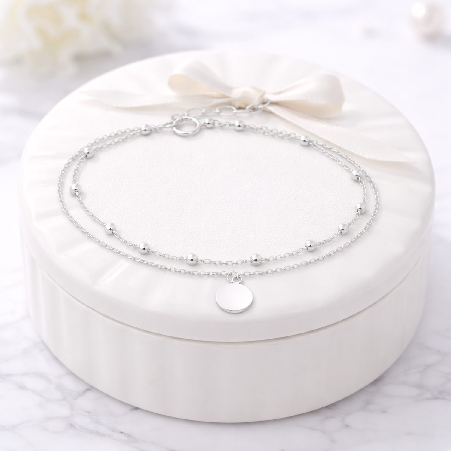 Melchior Jewellery sterling silver layered bracelet with delicate chains and small round charm on white box