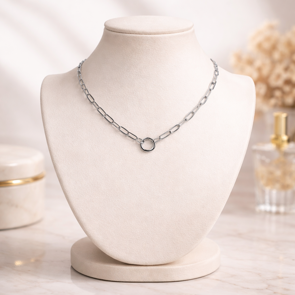 Silver paperclip charm holder chain necklace by Melchior Jewellery displayed on beige bust stand