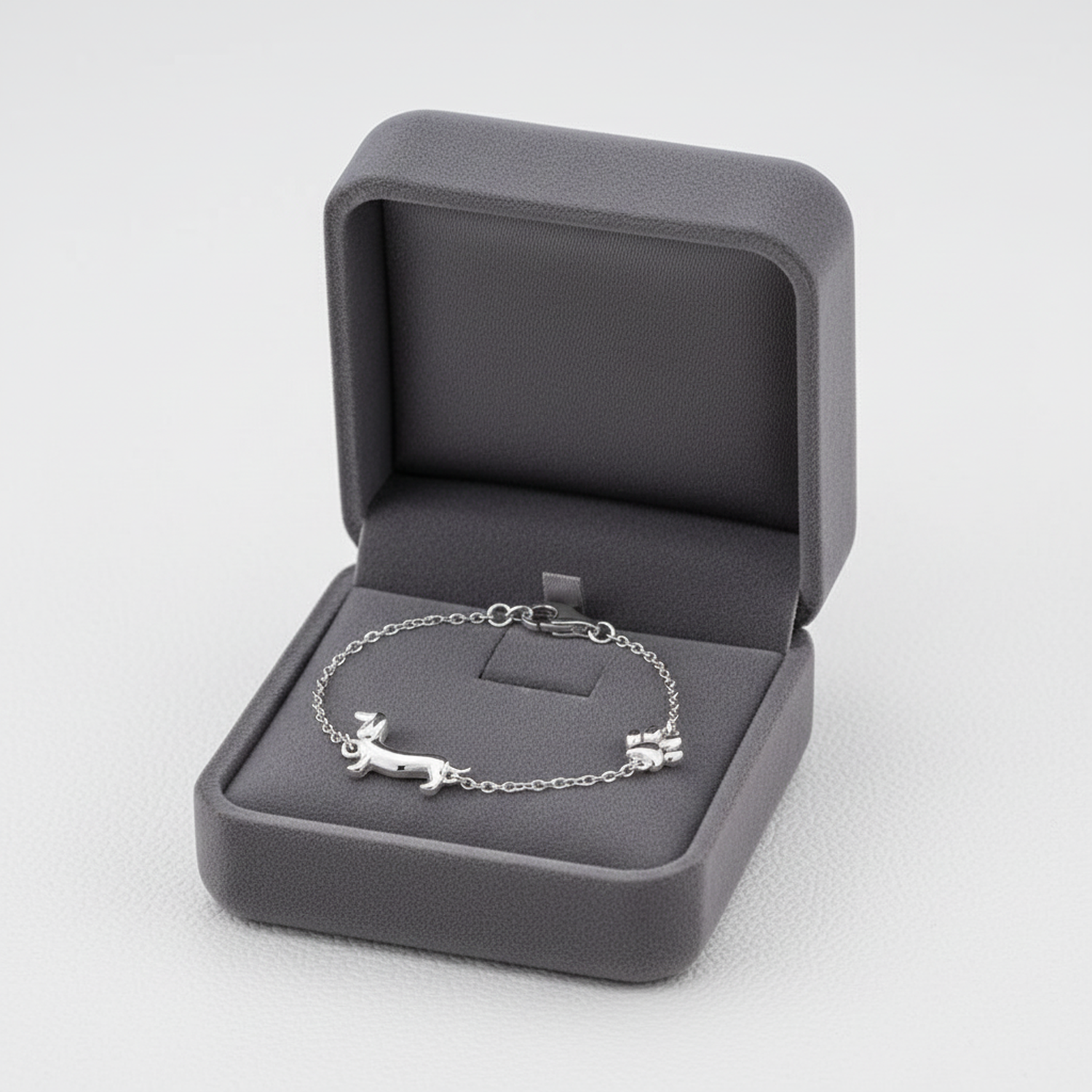 Melchior Jewellery sterling silver dachshund bracelet displayed in a grey velvet jewellery box