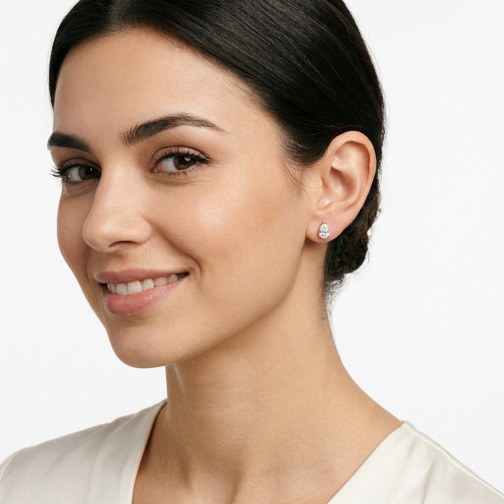 sterling silver white gold pear shape stud earrings on woman by Melchior Jewellery