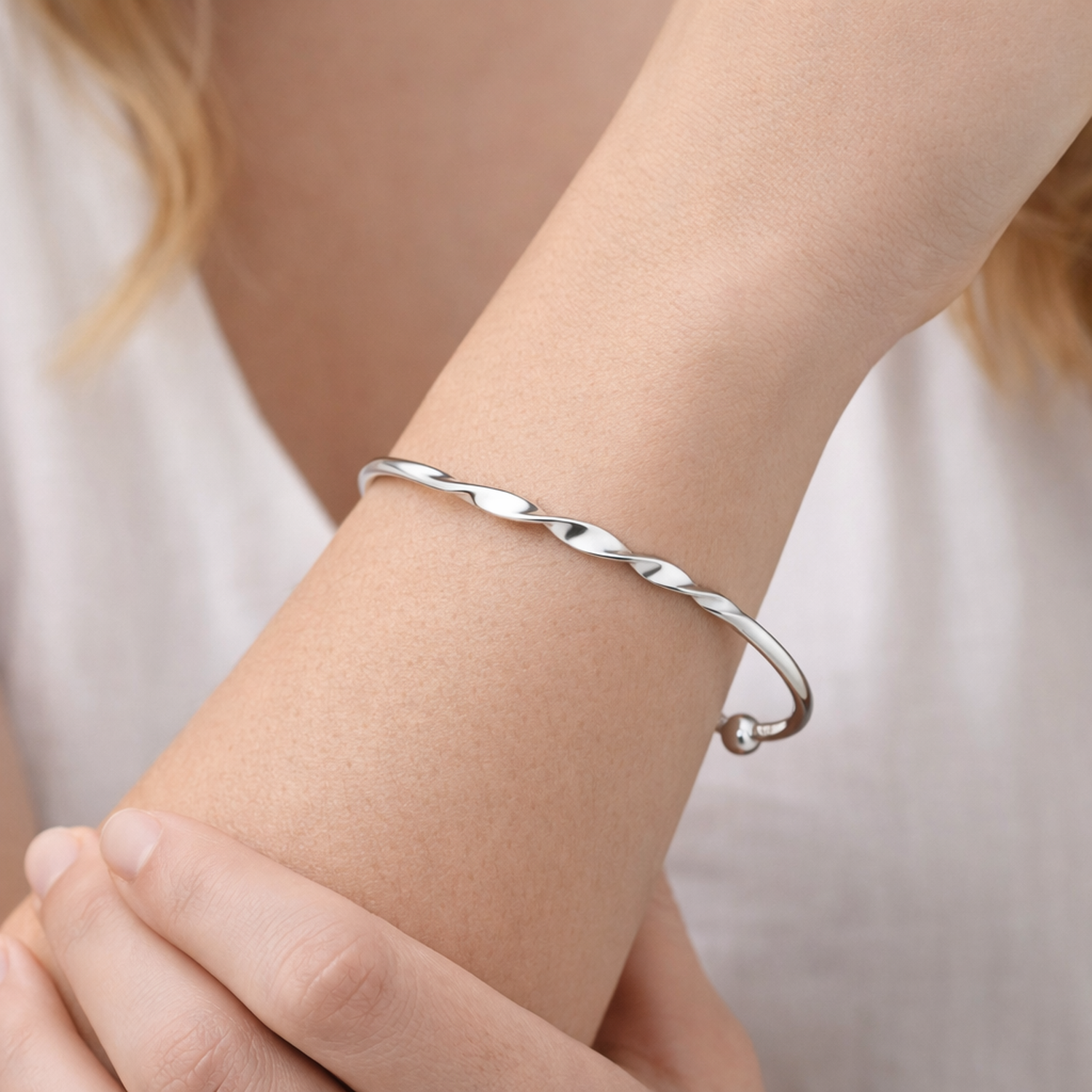 Sterling silver open cuff bangle for women by Melchior Jewellery worn on wrist with twisted design