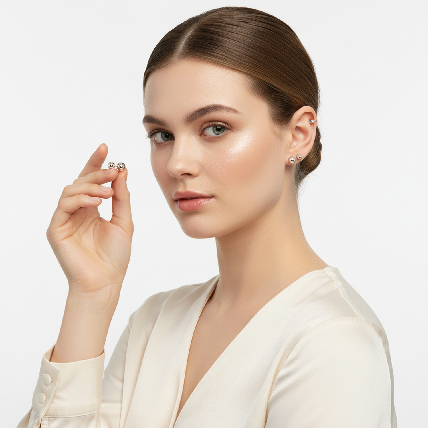 Melchior Jewellery sterling silver ball stud earrings for children shown on woman with neutral background