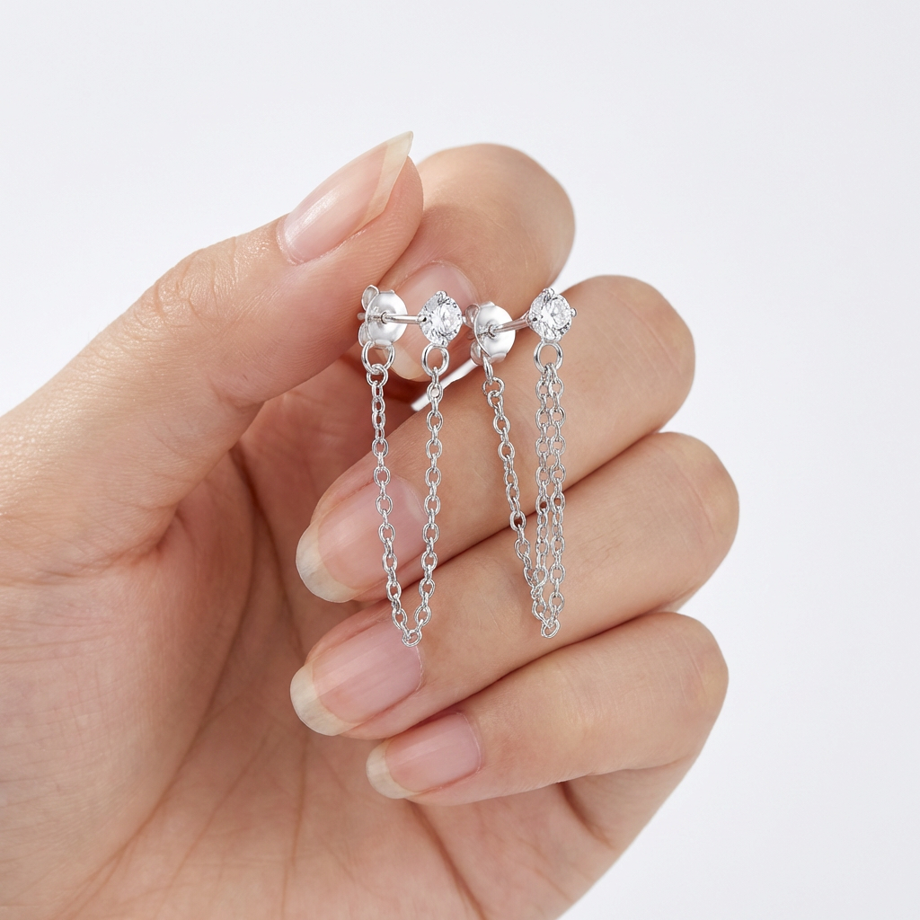 Sterling silver chain drop earrings with delicate linked chains held in hand by Melchior Jewellery