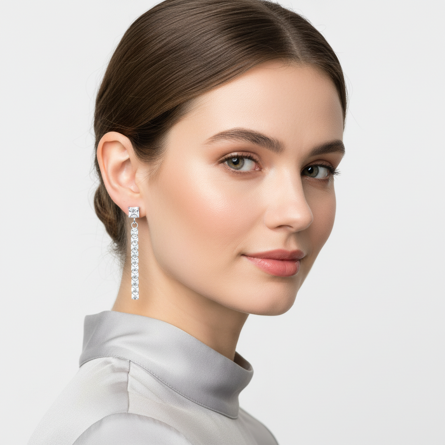 Melchior Jewellery sterling silver drop earrings worn by woman with elegant hairstyle and light grey top