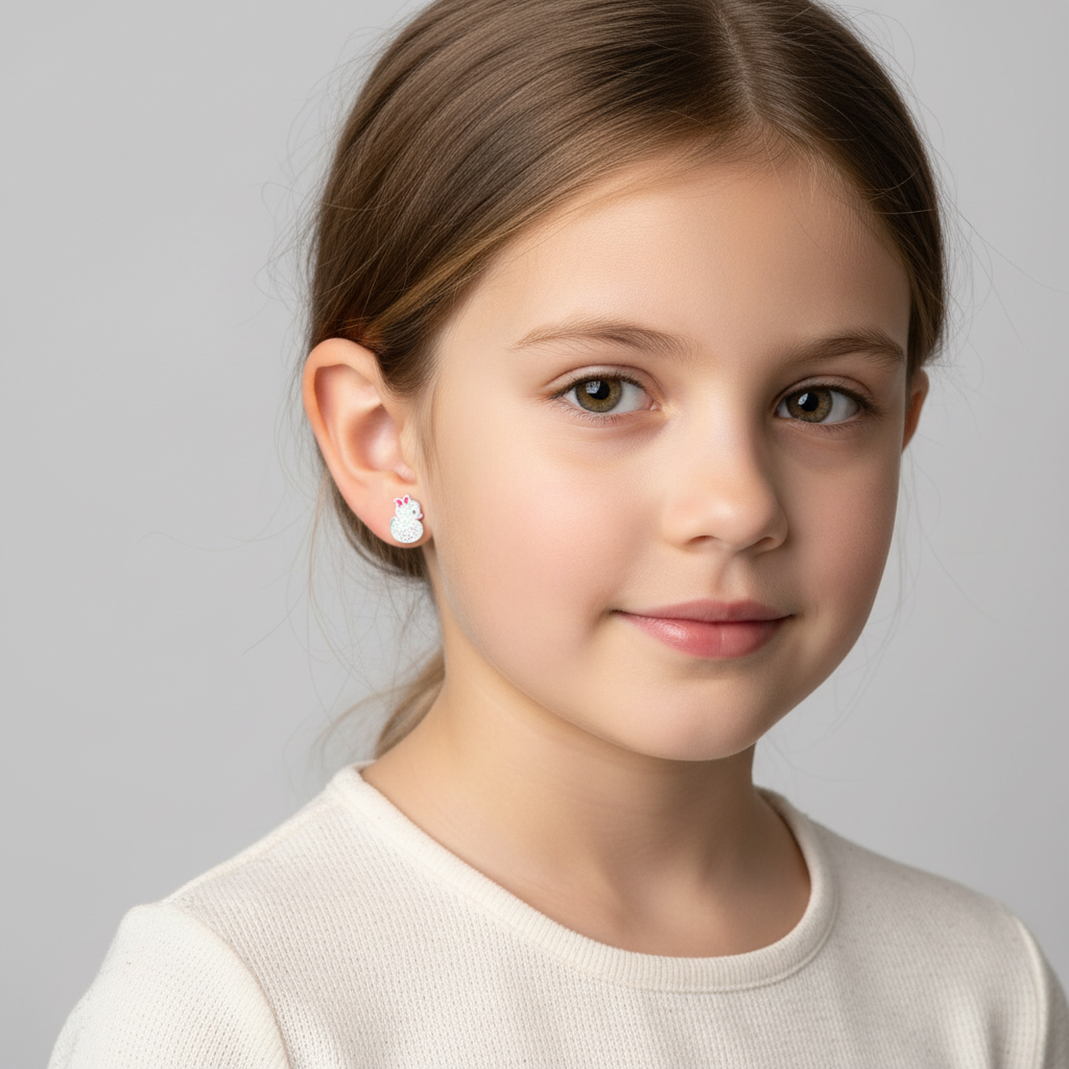 Young girl wearing Melchior Jewellery sterling silver duck earrings for kids in white top