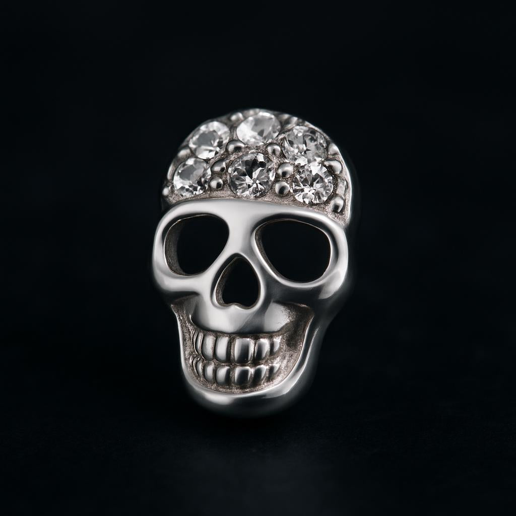 Melchior Jewellery sterling silver skull stud earrings with crystal embellishments on black background