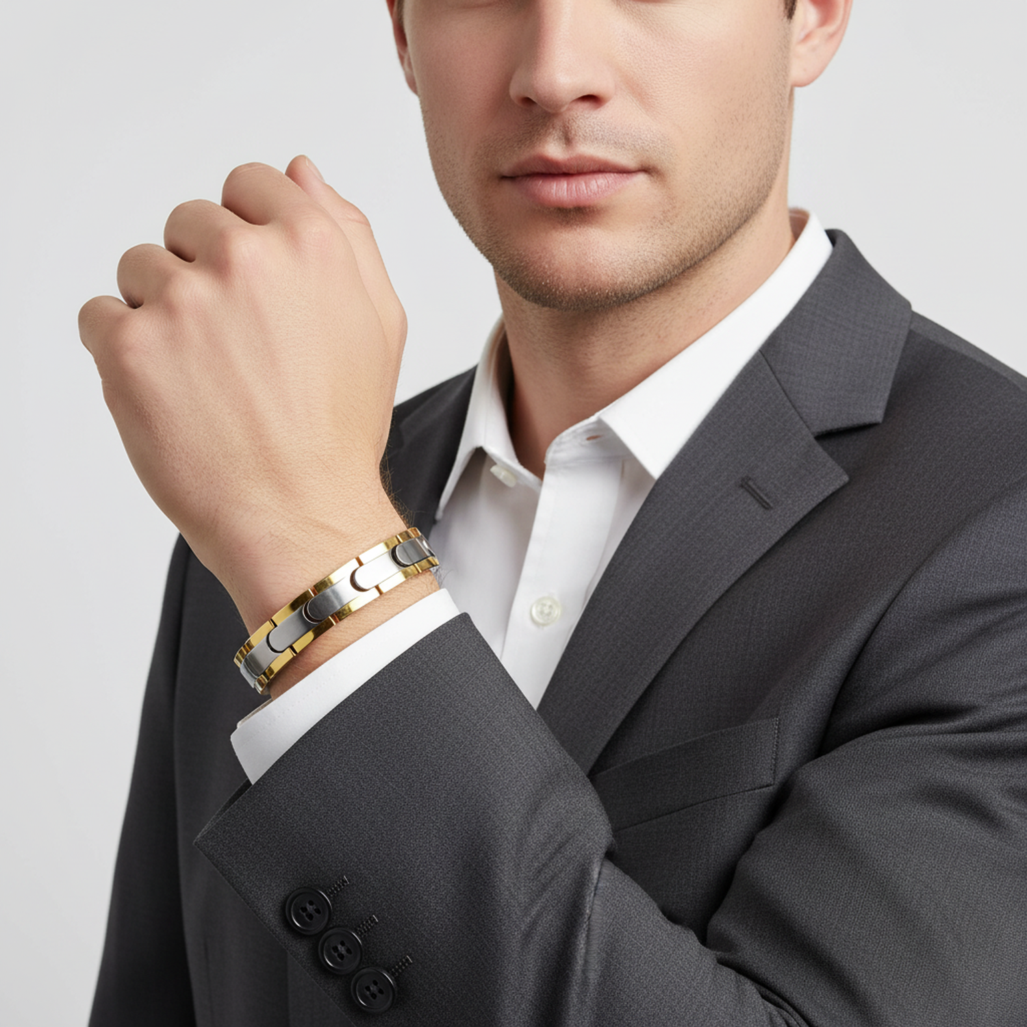 Melchior Jewellery dual-tone magnetic bracelet worn on wrist with gold and silver links in formal attire