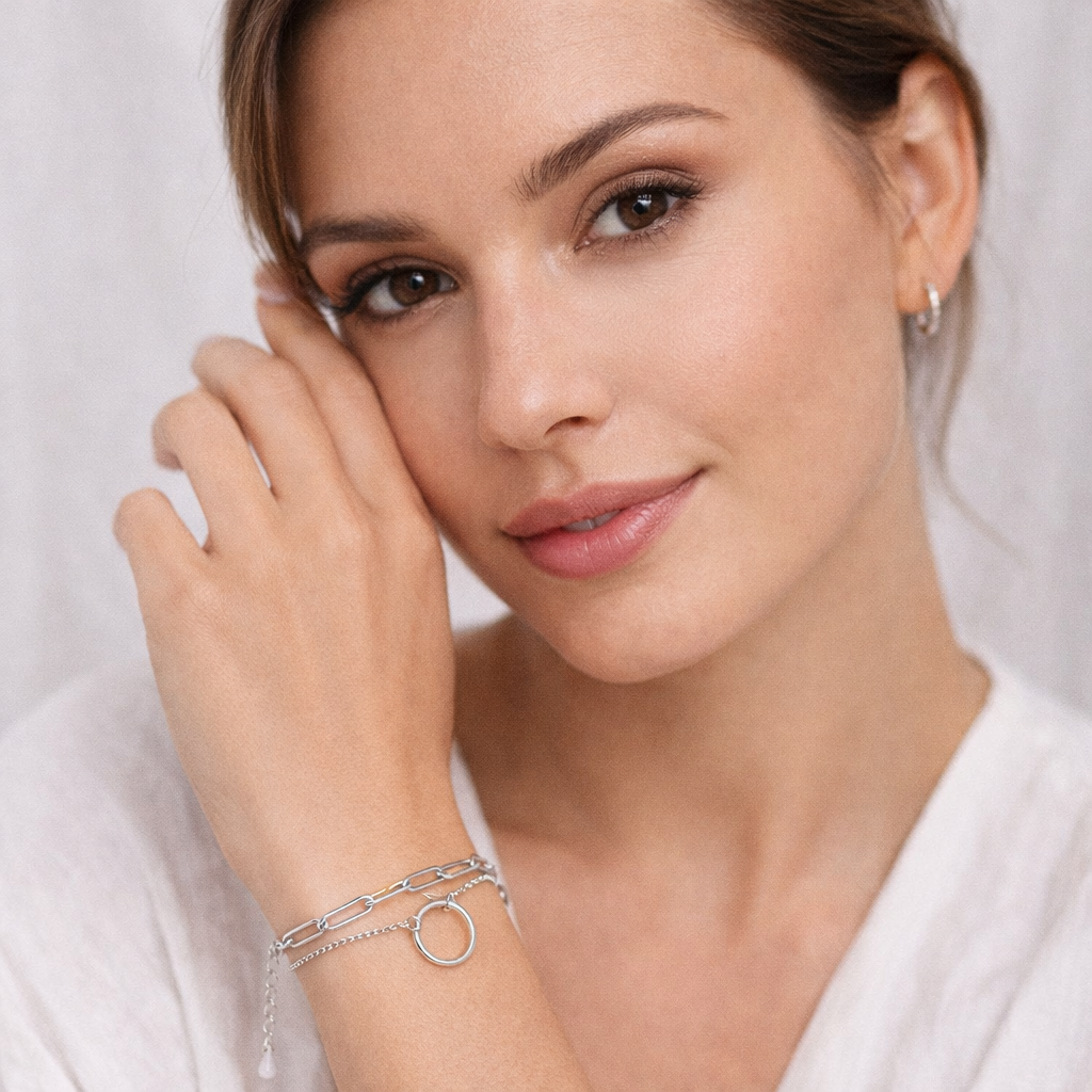 Sterling silver halo link bracelet from Melchior Jewellery worn on wrist by woman with soft makeup