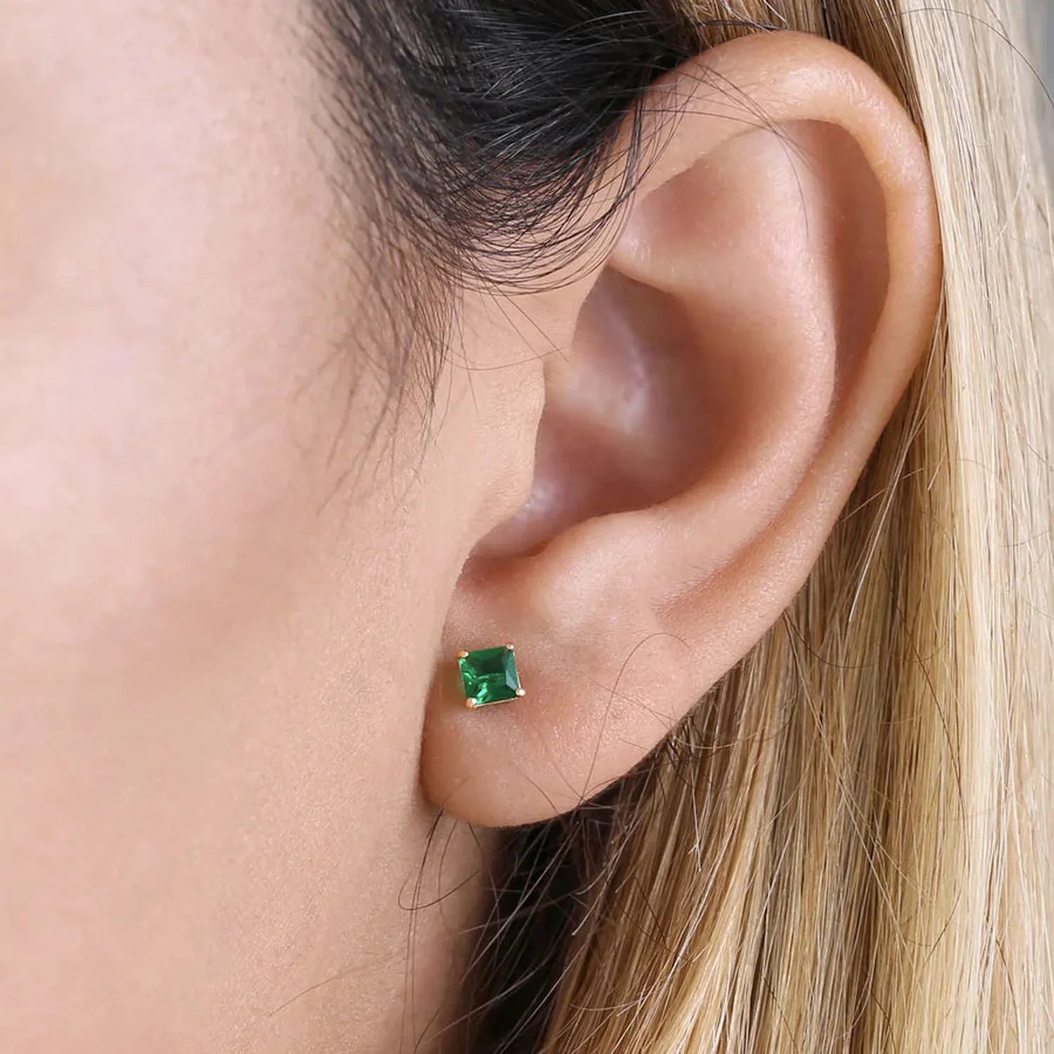 Melchior Jewellery princess cut emerald CZ earrings with vivid green stones set in sterling silver on ear