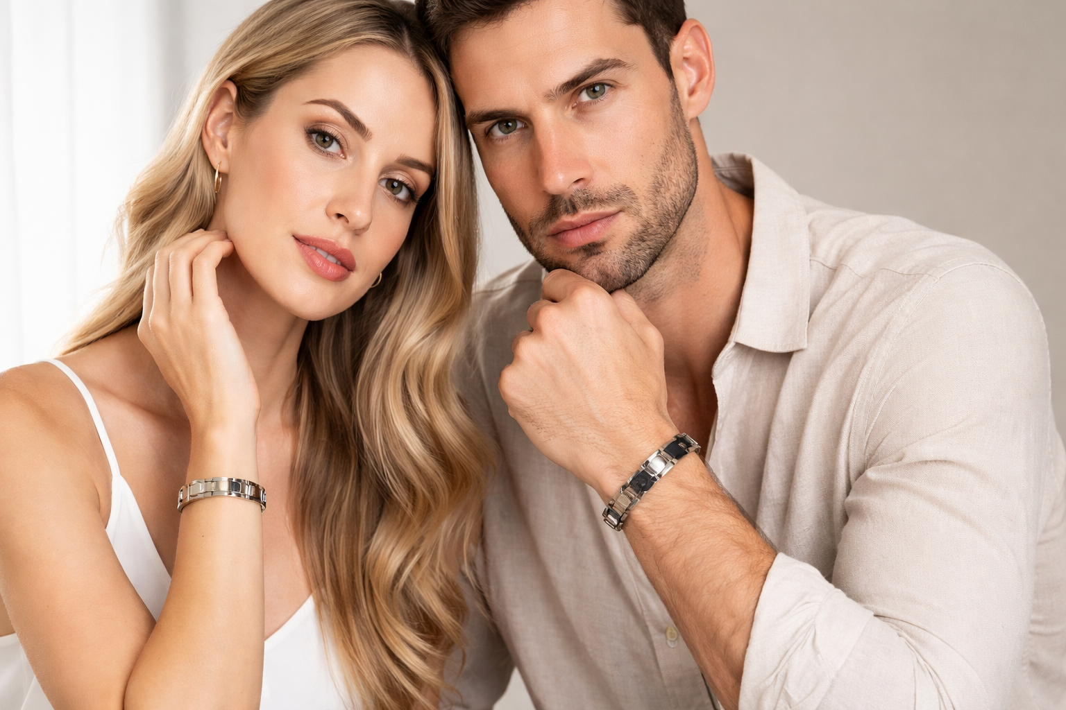 Stylish couple wearing matching silver bracelets, showcasing elegance and modern design.