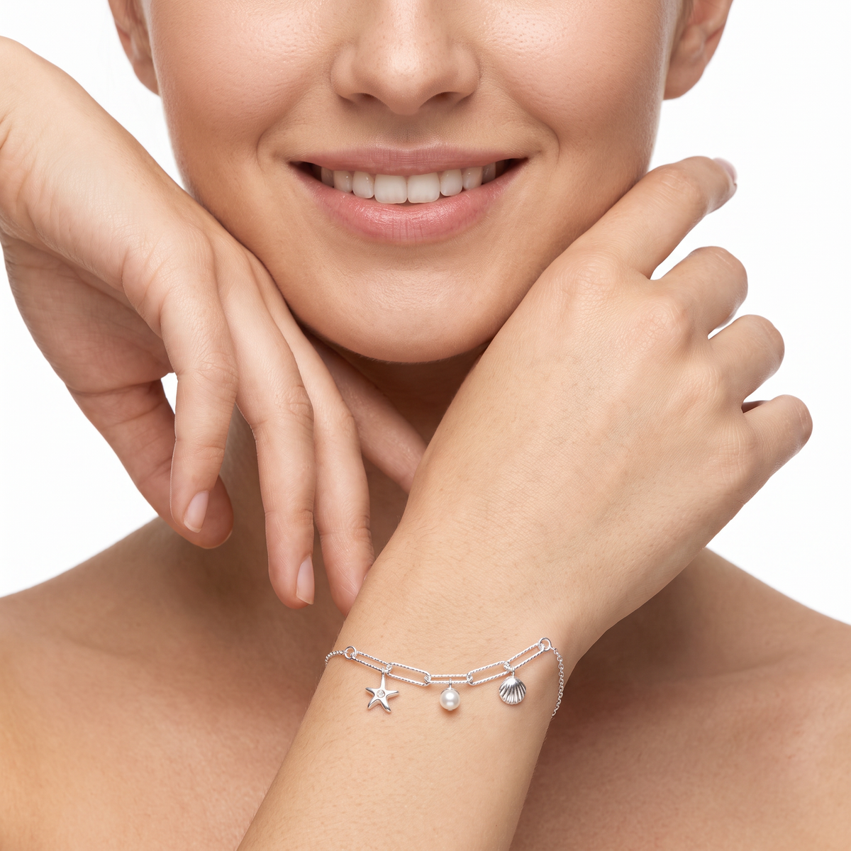 Close-up of the shell and starfish charms on a sterling silver bracelet