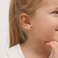 14k white gold baby girl earrings with small blue heart studs worn by young child