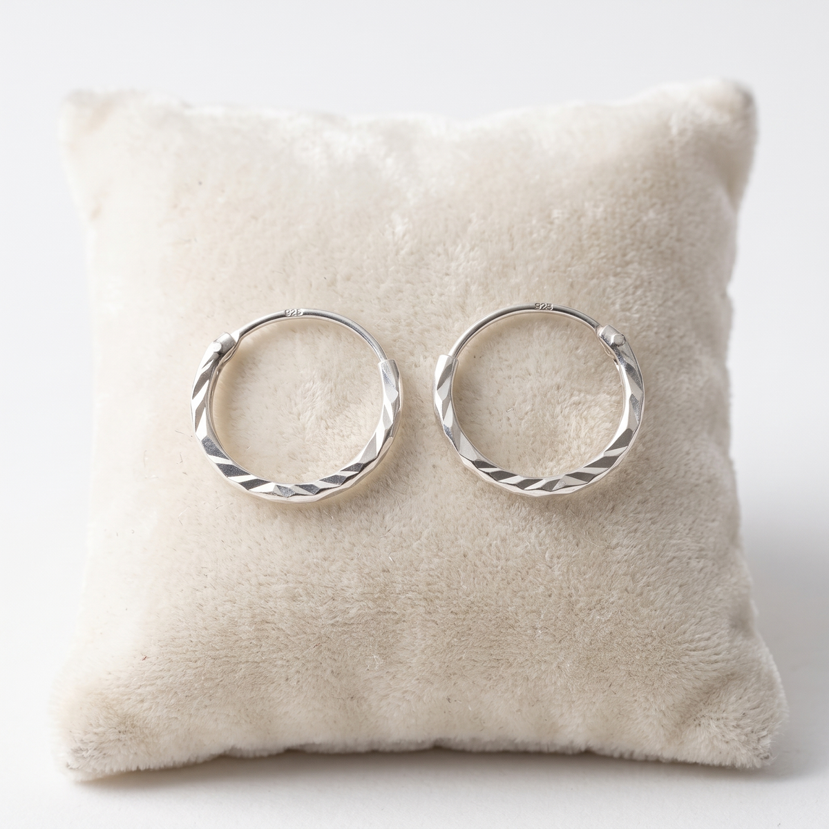 12mm sterling silver diamond cut hoop earrings on Jewellery Cushion