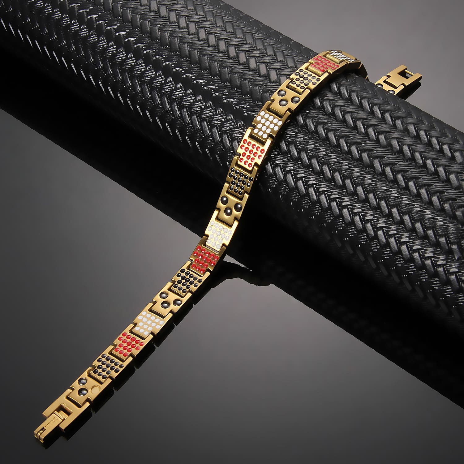Melchior Jewellery 4in1 elements magnetic bracelet in gold with black red and white details on black textured background
