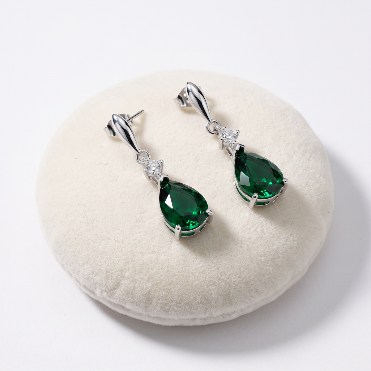 925 Sterling Silver CZ Emerald Pear Shaped Drop Earrings On Jewellery Cushion