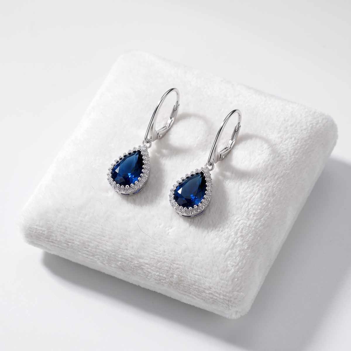 Sterling silver sapphire earrings displayed on a Jewellery Cushion