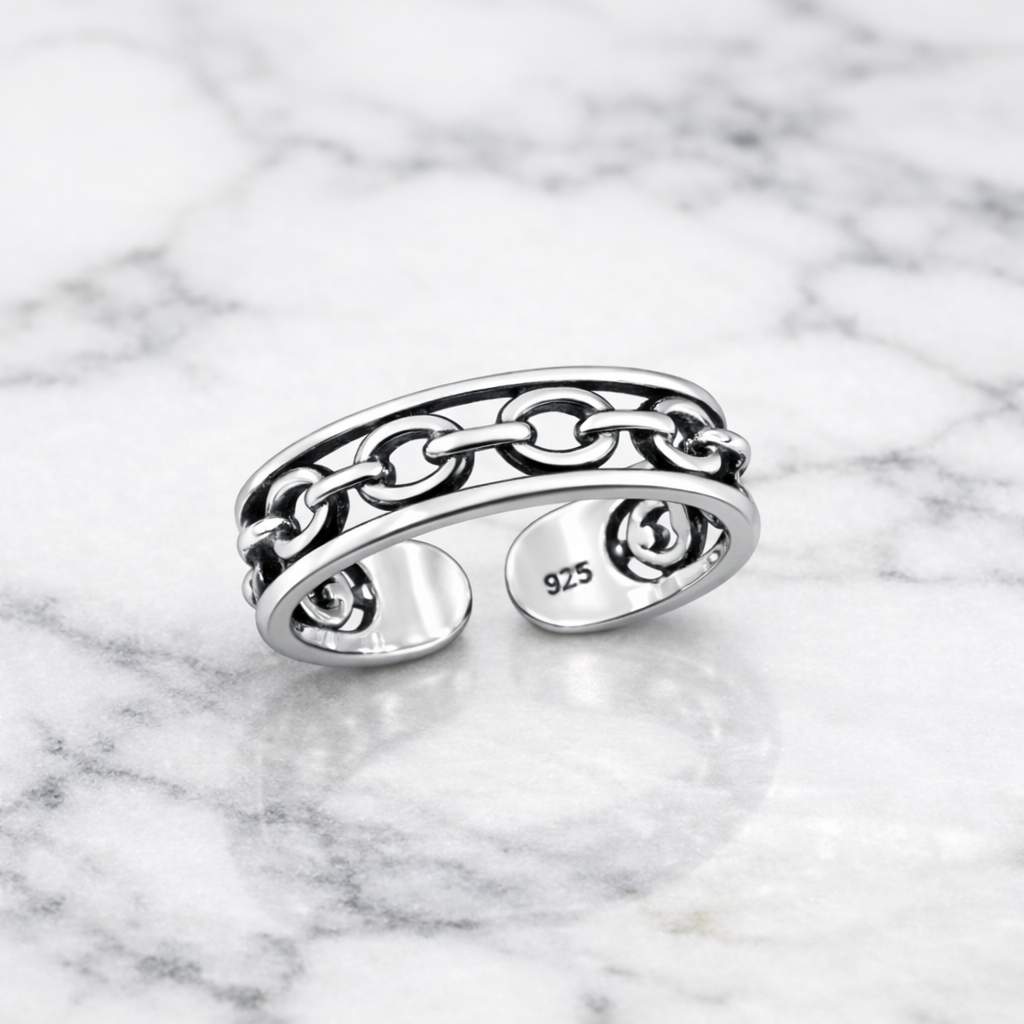 Sterling Silver Chain Toe Ring with open design and chain detail by Melchior Jewellery on marble surface