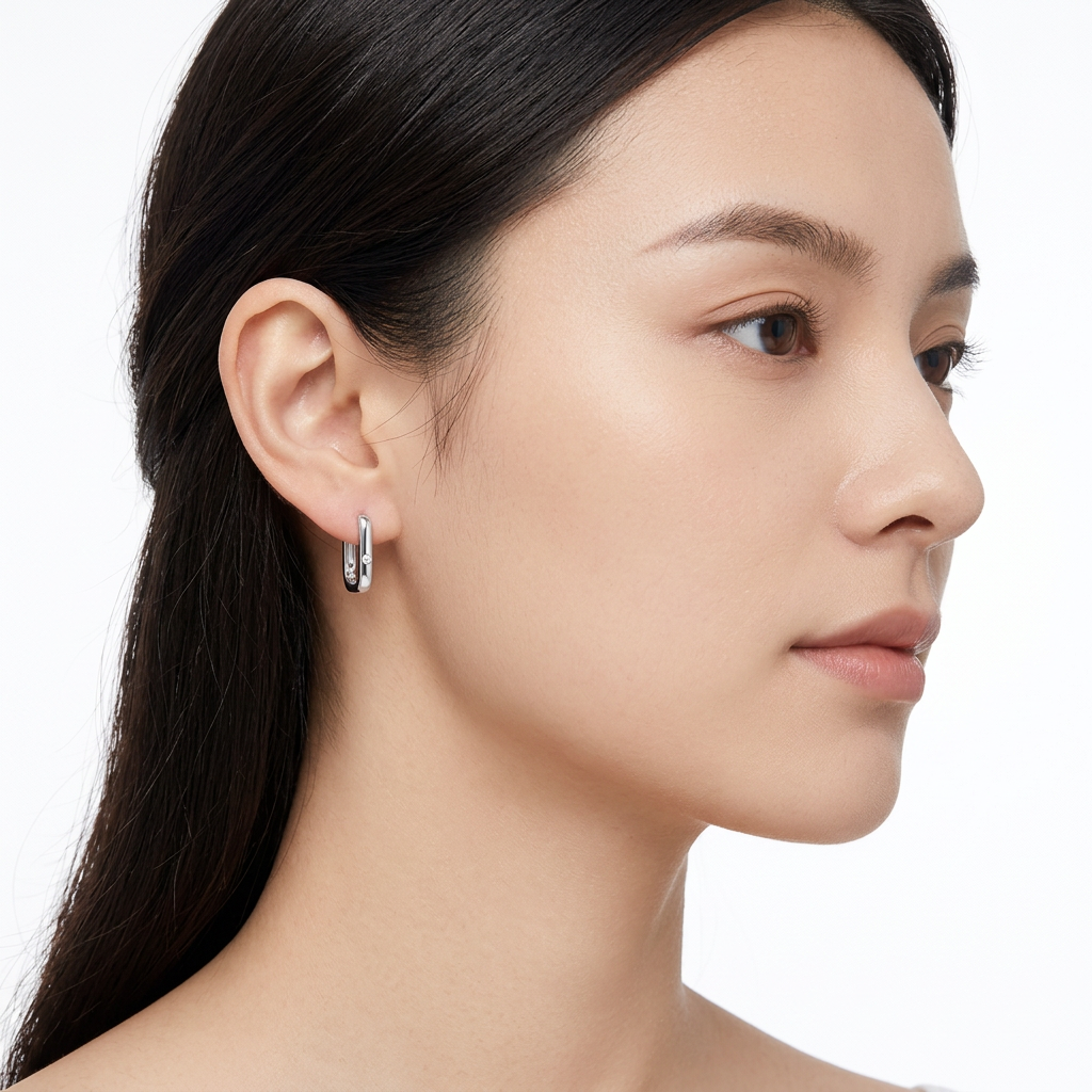 Silver Hoop Earrings showcasing a sleek design worn by a model.
