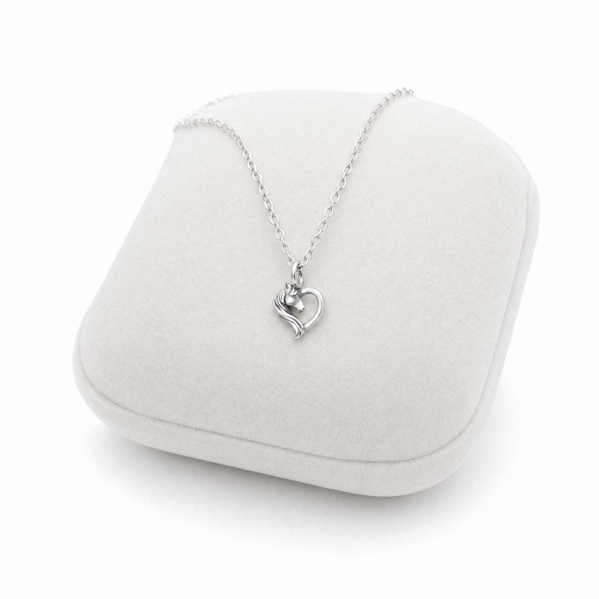 Girls sterling silver horse heart necklace on Jewellery Cushion