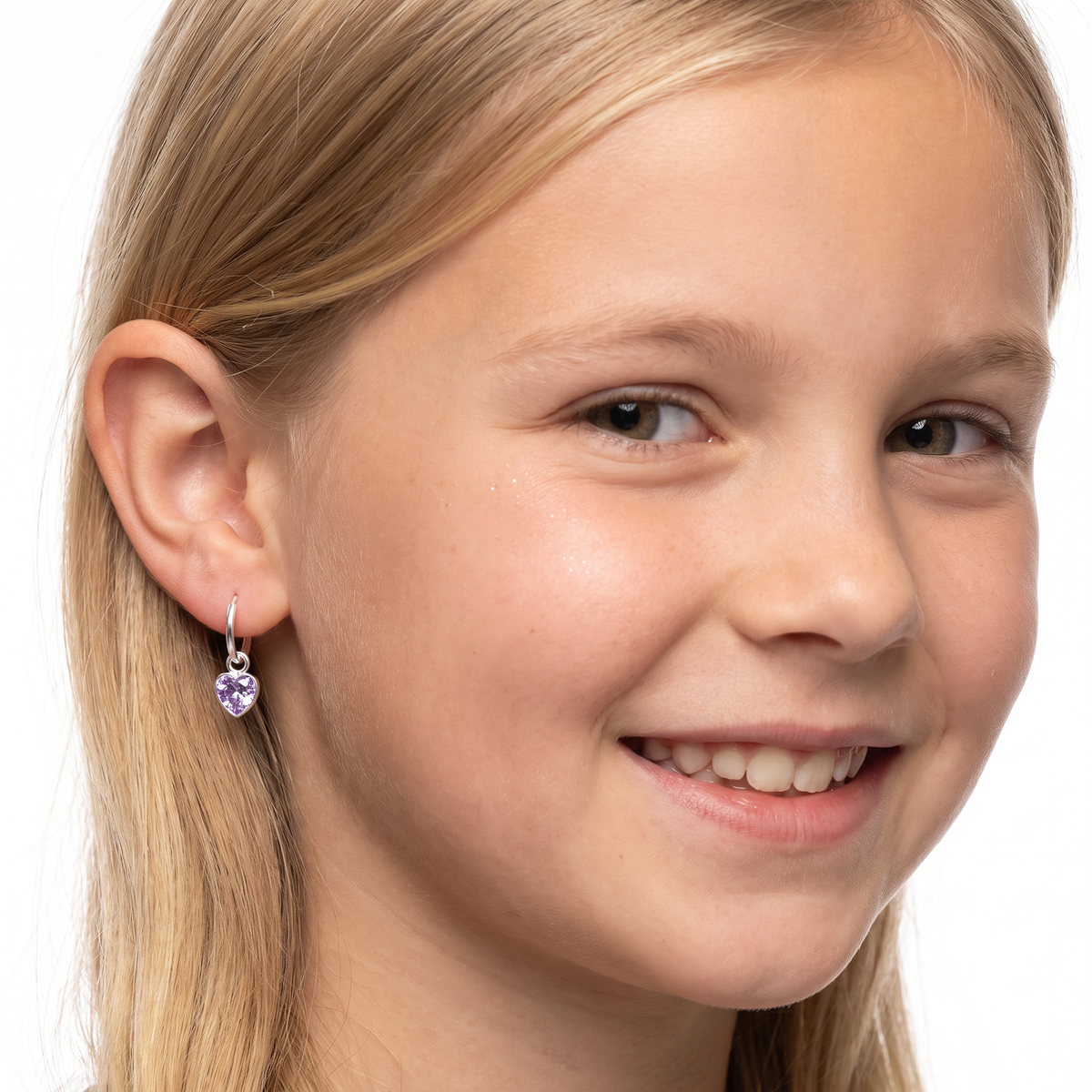 Close-up of lavender heart-shaped cubic zirconia charms on sterling silver hoop earrings