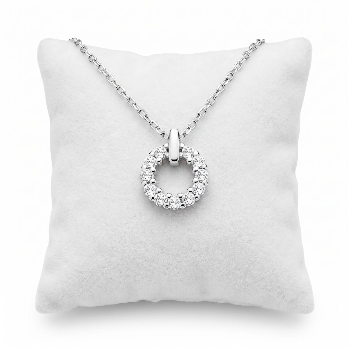 Close-up of circular sterling silver necklace with sparkling white cubic zirconia