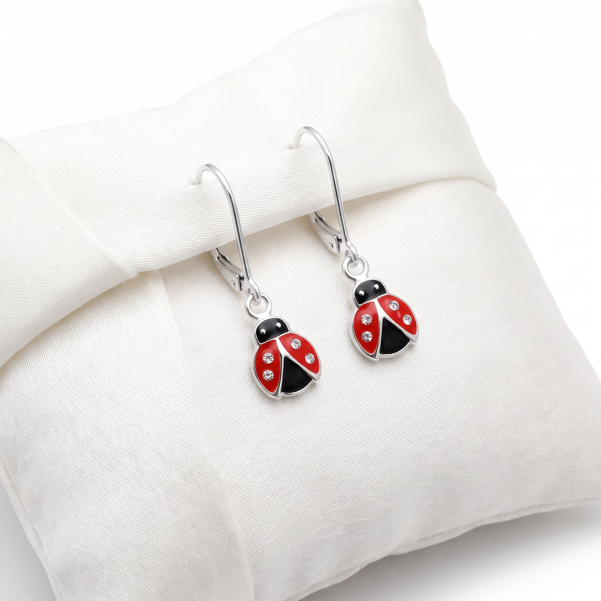 Girls sterling silver ladybird leverback CZ earrings on Jewellery cushion display