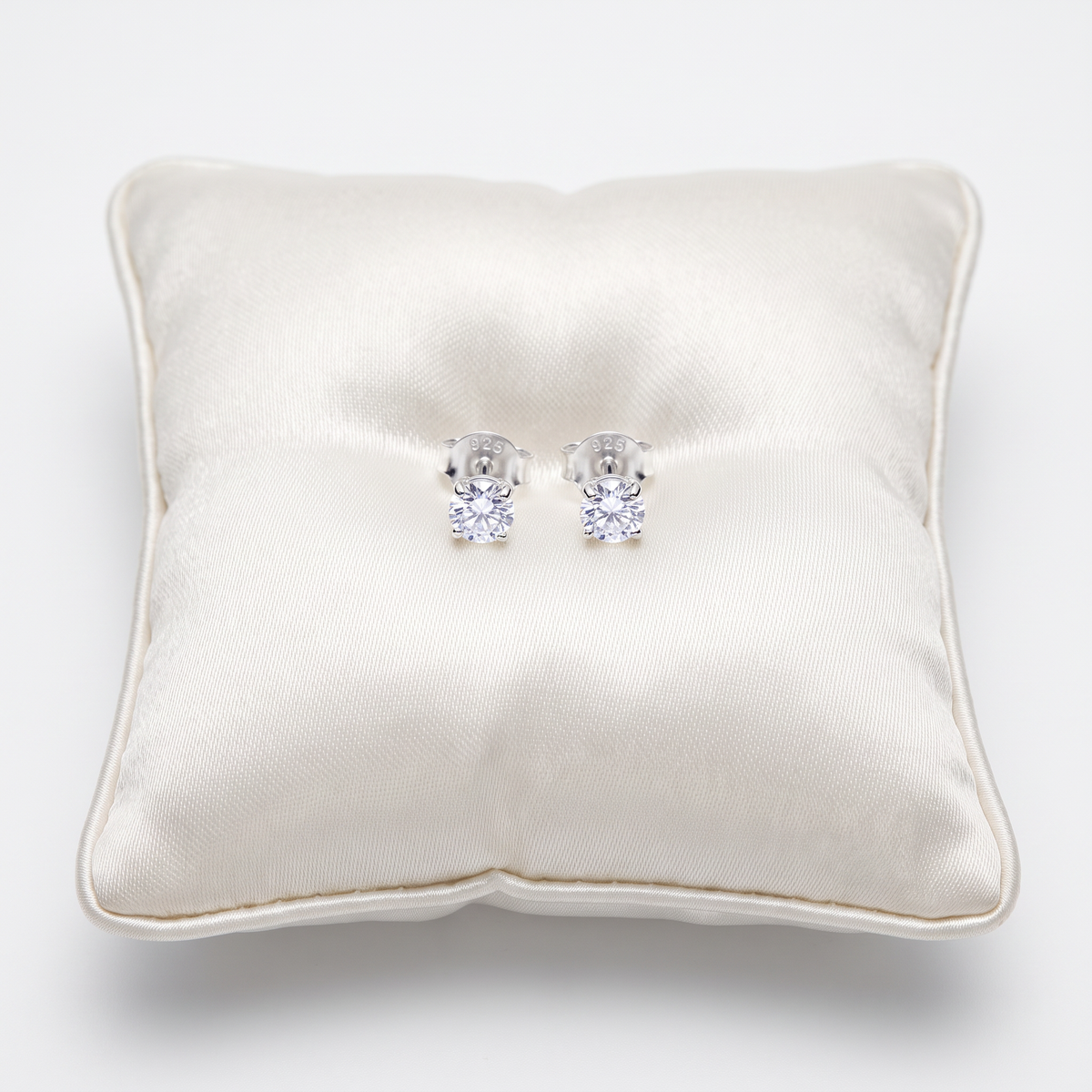 Sterling S on jewellery cushion
ilver 3mm Round Moissanite Stud Earrings