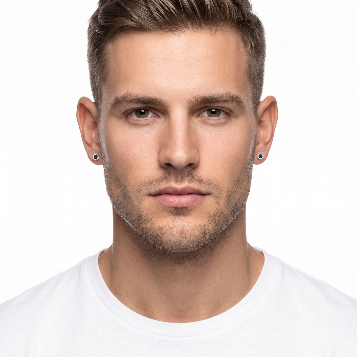 A close-up portrait of a man wearing small black round stud earrings