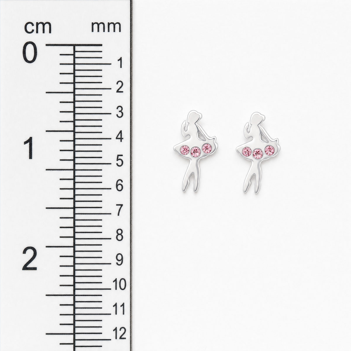 A pair of silver ballerina stud earrings with pink rhinestones, shown next to a centimeter and millimeter ruler for scale.