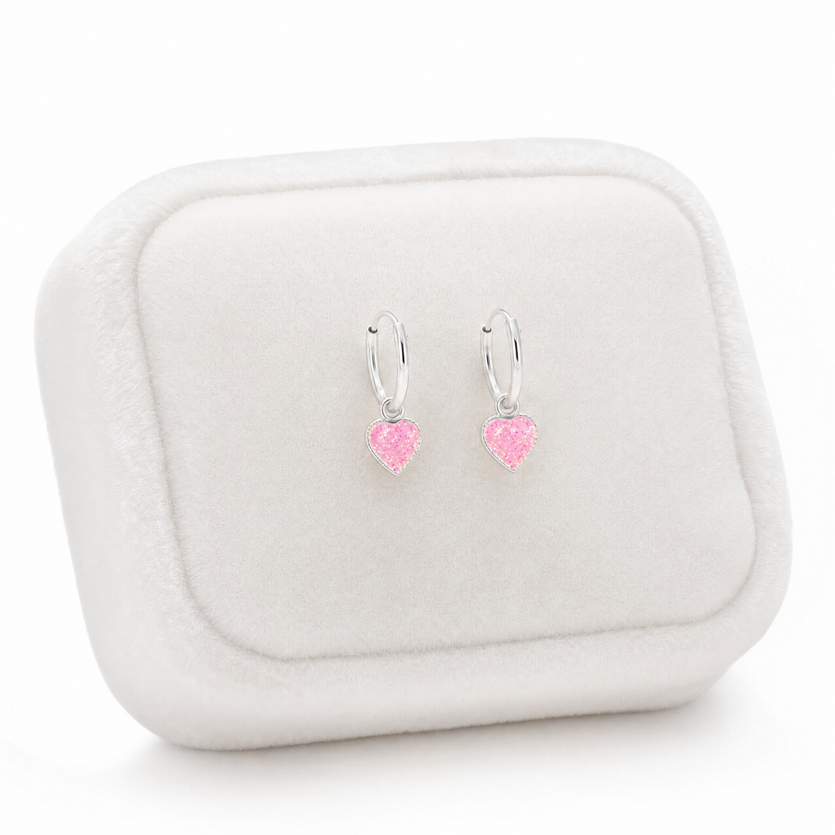 Sterling silver girls pink glitter heart charm hoop earrings on Jewellery cushion
