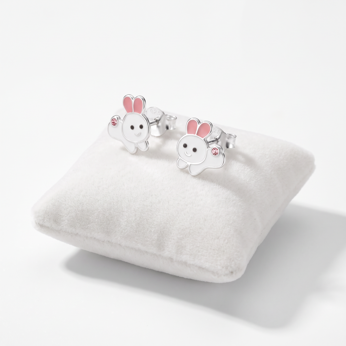 Girls’ sterling silver bunny rabbit stud earrings on jewellery cushion