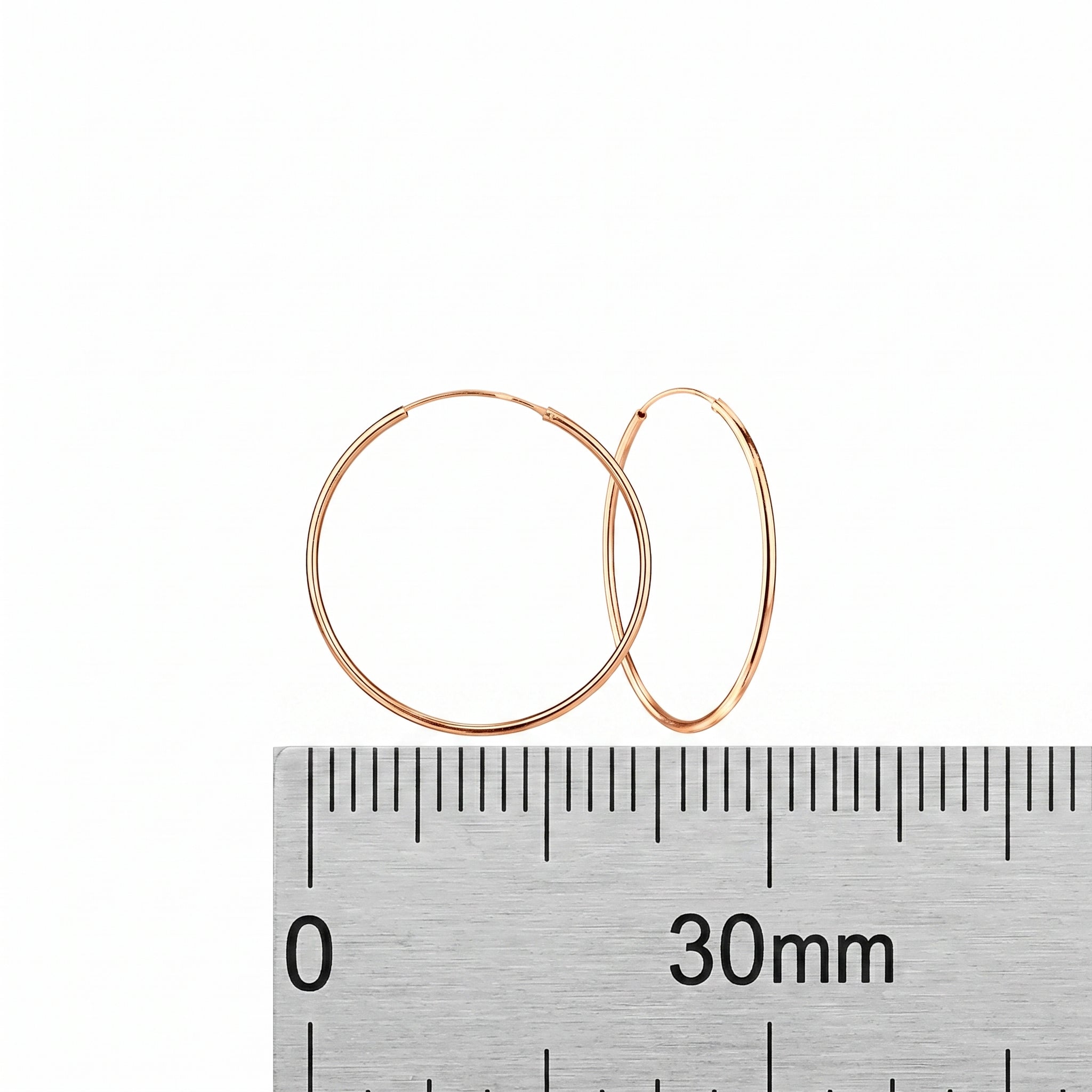Close-up of sterling silver rose gold hoop earrings