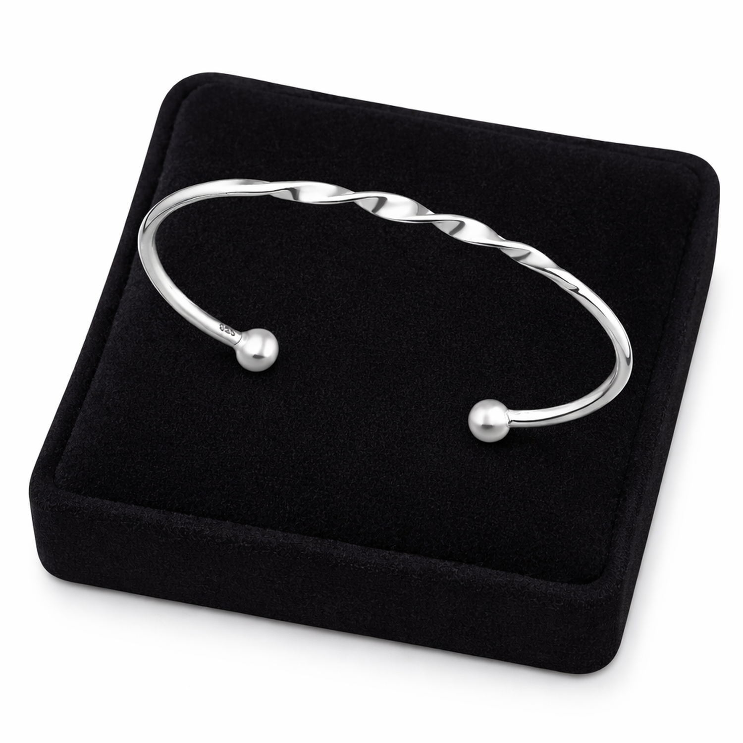 Sterling silver open cuff bangle for women with twisted design by Melchior Jewellery on black display