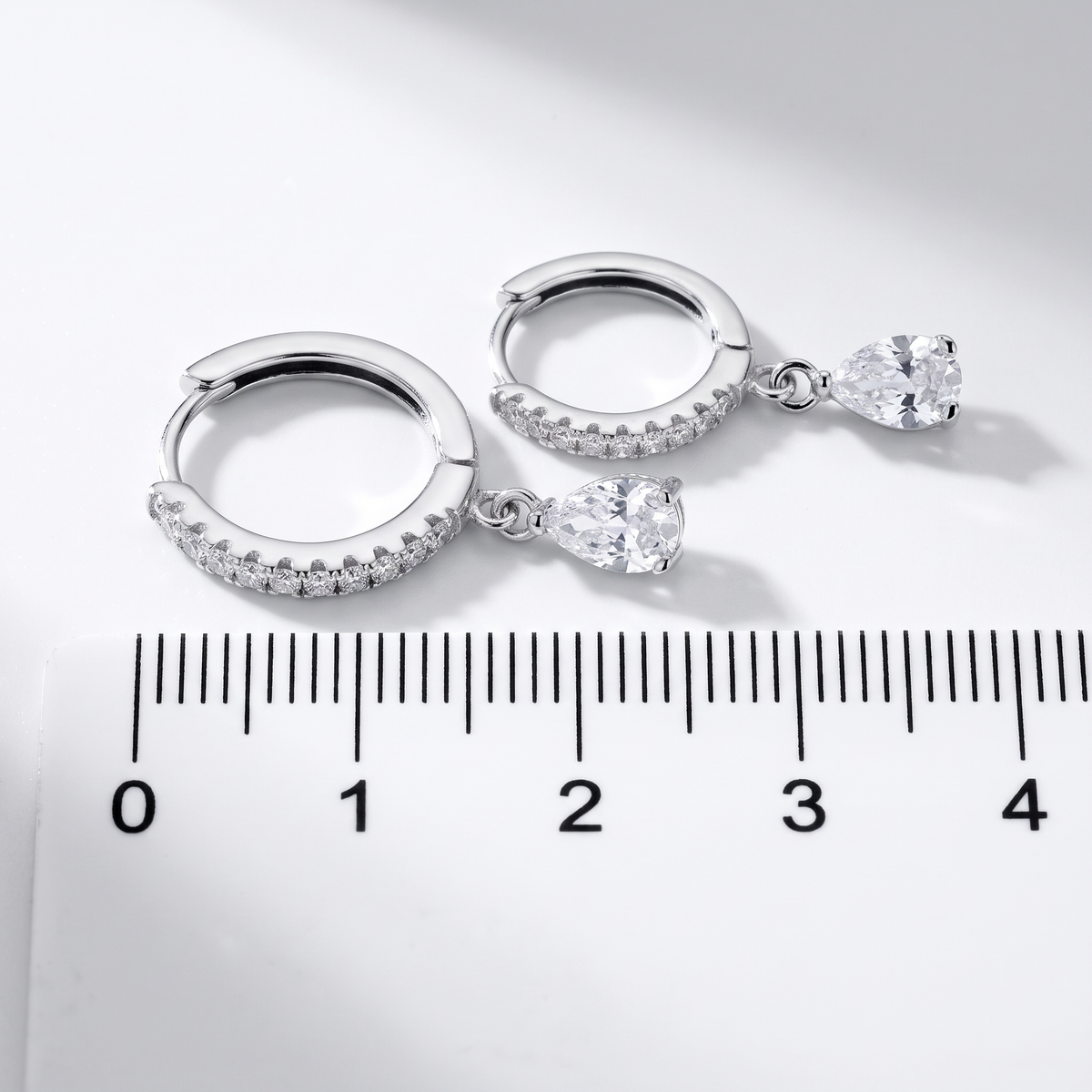 Sterling Silver White CZ Teardrop Birthstone Earrings Showing Size