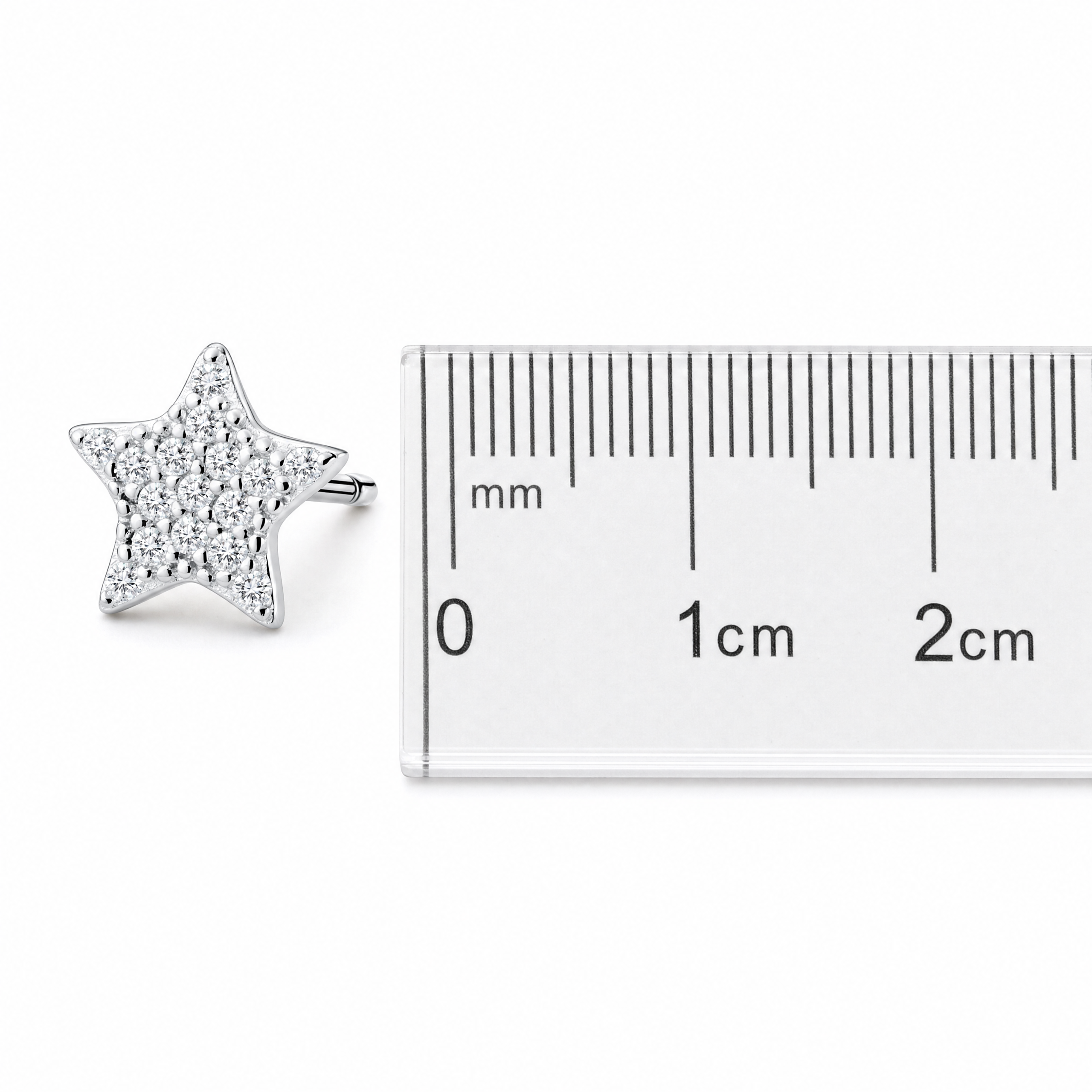 Sterling silver star stud earring shown beside ruler for size