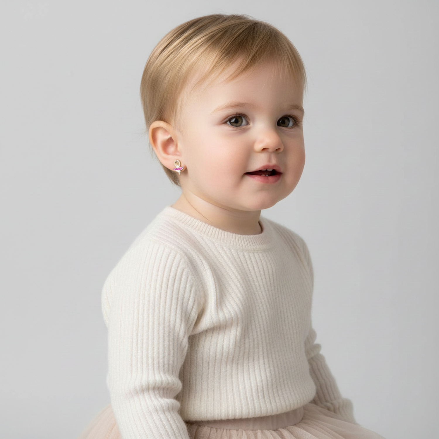 Toddler wearing ballerina stud earrings for girls by Melchior Jewellery in a white knitted top and tutu skirt