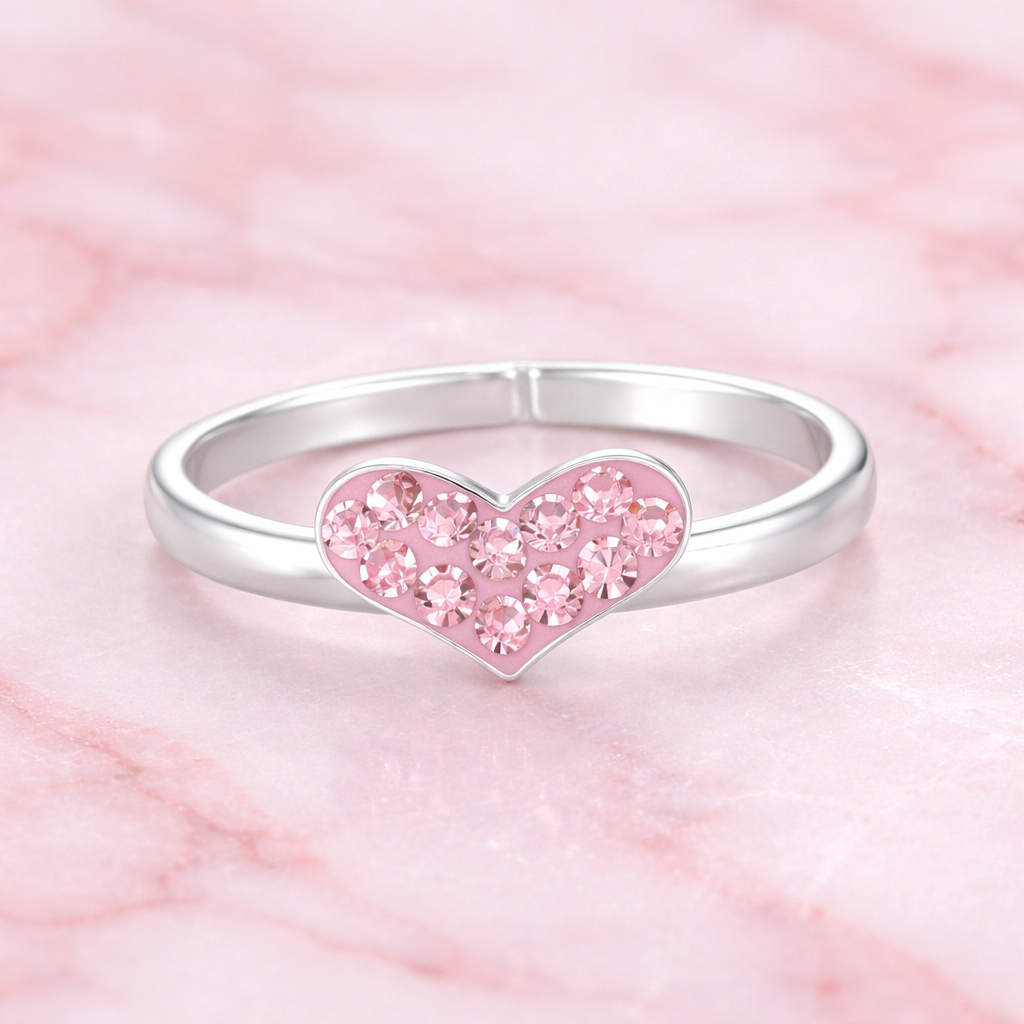 Girls pink crystal heart ring by Melchior Jewellery featuring a silver band and sparkling pink crystals on heart-shaped design