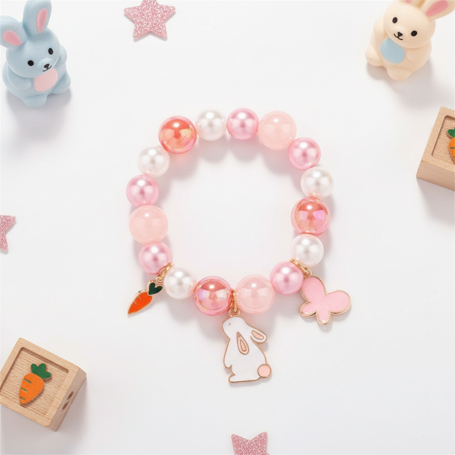 Girls rabbit bracelet by Melchior Jewellery with pink and white beads featuring rabbit, carrot, and butterfly charms