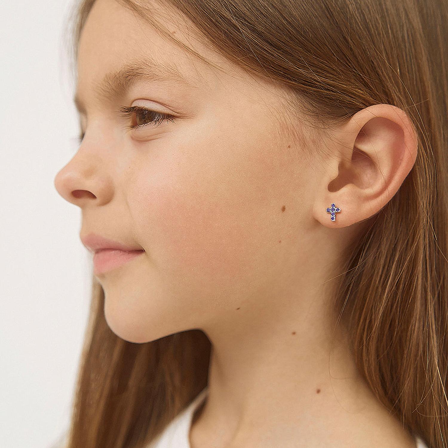 Sterling silver children silver cross earrings with blue stones worn by young girl from In Season Jewellery