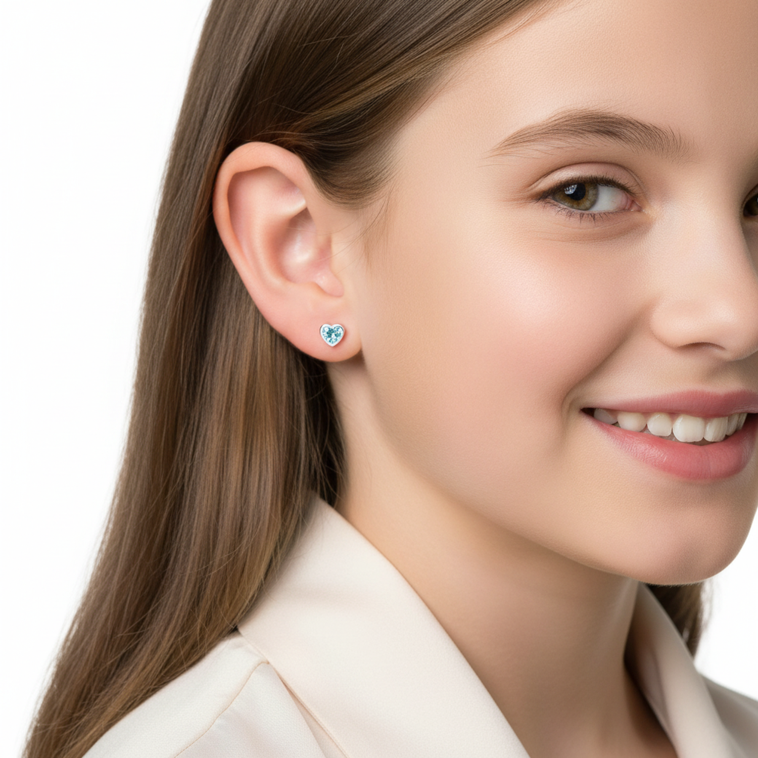 Sterling silver childrens aquamarine heart earrings worn by smiling young girl with brown hair