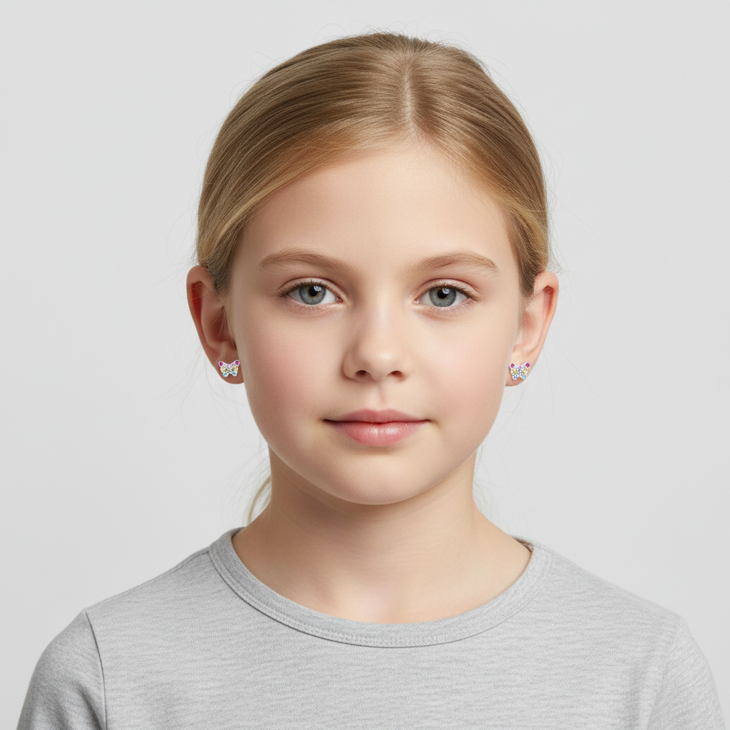 Sparkle butterfly earrings for girls worn by a young girl, Melchior Jewellery delicate stud design