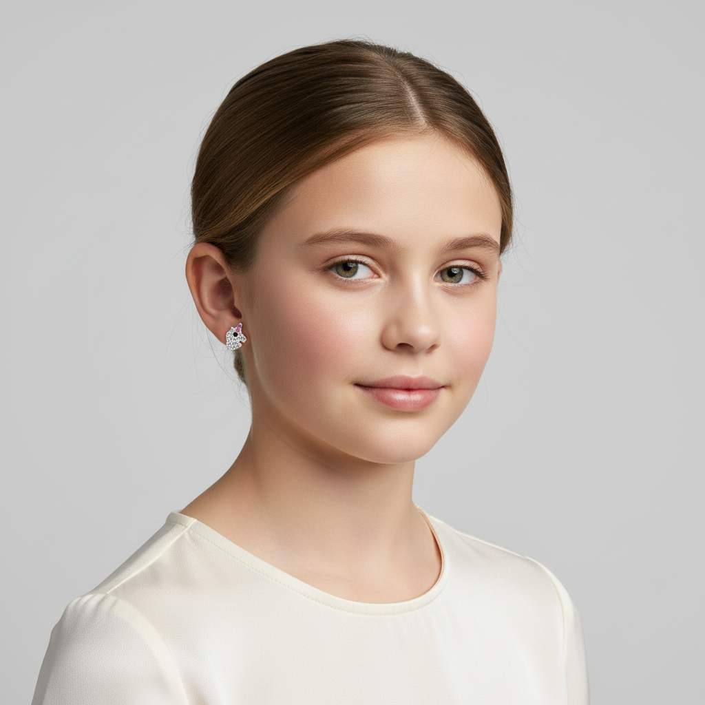 Young girl wearing crystal unicorn stud earrings for kids by Melchior Jewellery in white background